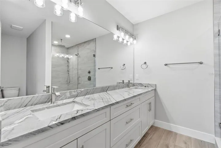 Primary bath with a double vanity and a glass shower